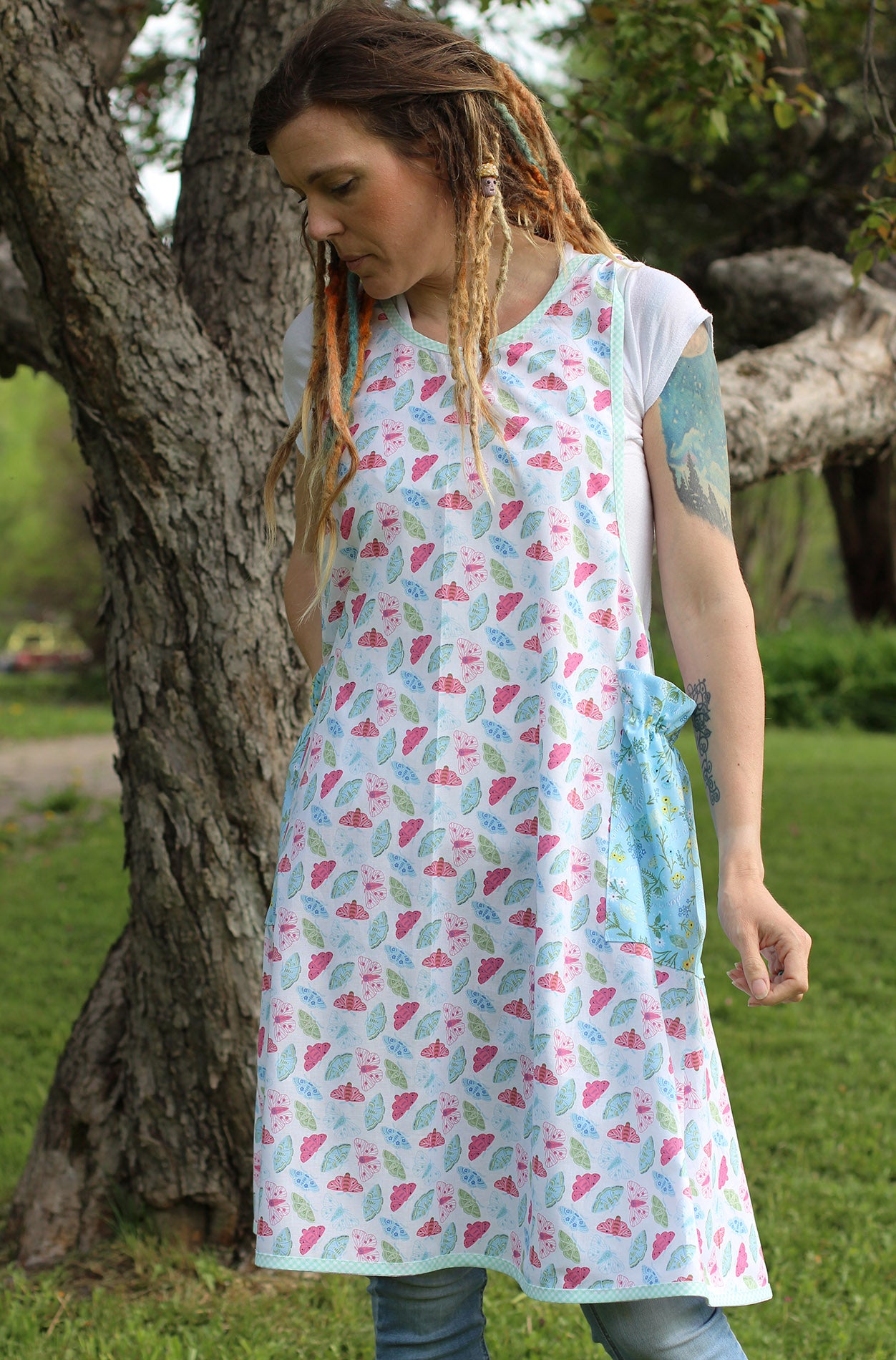 No Tie Apron in Butterflies - Model wears front view with dreads.