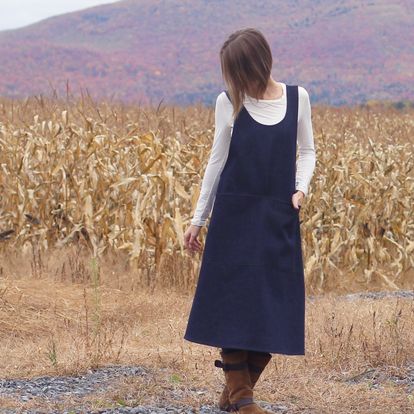 No Tie Crossback Apron in Heavy Denim - Front view with model standing in front of a field of drying corn.